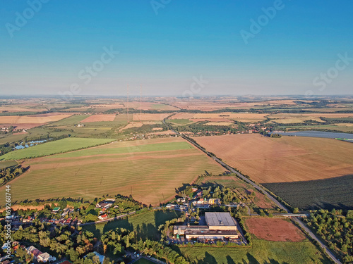 Summer landscape with radio/television transmitters and blue sky from airplane in Central Europe - Czechia