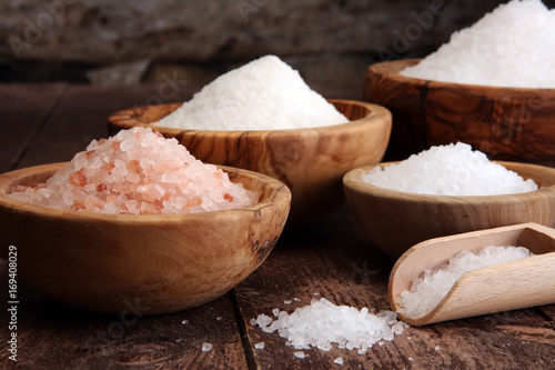 sea salt in bowl. Crystals of salt on table and himalayan salt