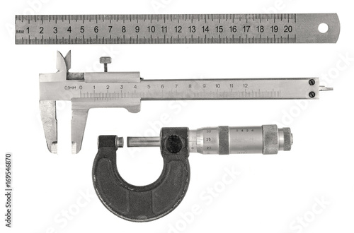 Three old measurement tools - ruler, calipers and micrometer on white background