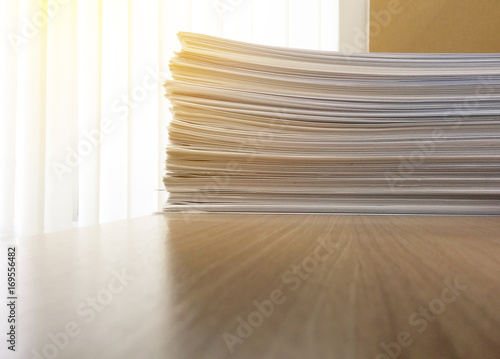 Business file documents paper stack on office wood table