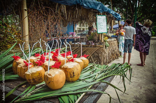 Exotic coctails made of fresh coconuts and the tourists, Seychelles