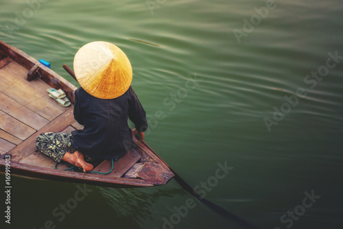 A woman rowing boat in Cai Rang