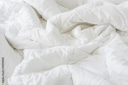 Close up messy white sheet and pillows on bed bedroom interior