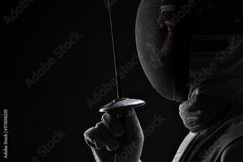Male fencer with Mask holding the sword in front of his
