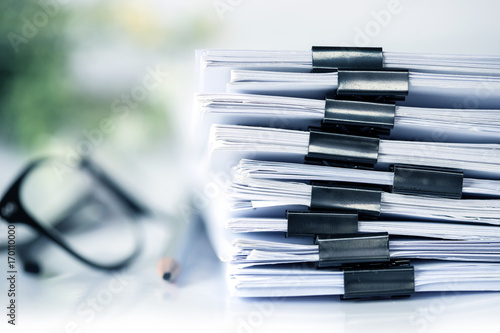 extreamly close up the stacking of office working document with paper clip folder