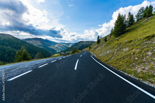 Asphalt road in Austria, Alps in a summer day.