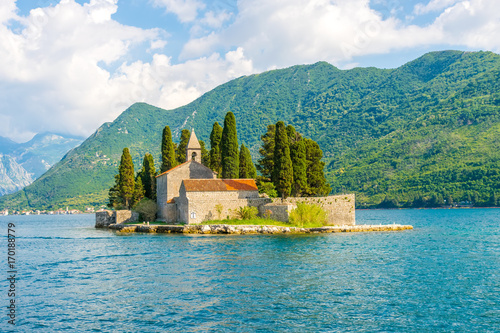 The yacht sails near the picturesque island of St. George in the Bay of Kotor.