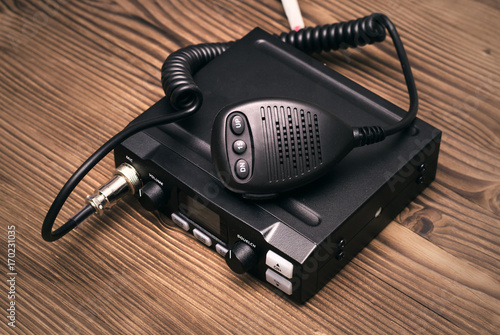 cb Radio transmitter isolated on wooden table background.