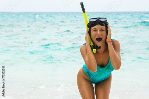 Happy woman on the beach with mask for snorkeling