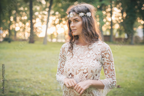 Beautiful woman wearing lace dress and circlet of flowers