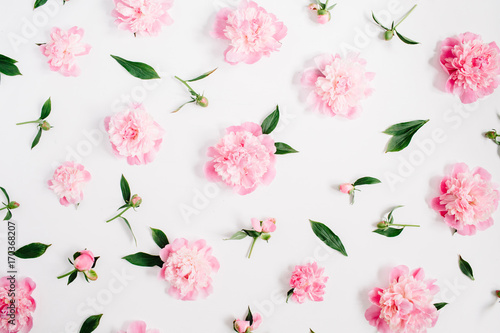 Flower pattern of pink peony flowers, branches, leaves and petals on white background. Flat lay, top view. Peony flower texture.