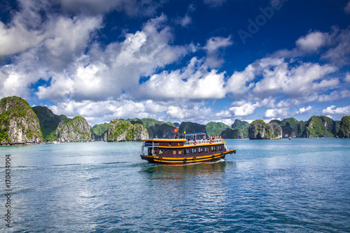 cruising among beautiful limestone rocks and secluded beaches in Ha Long bay, UNESCO world heritage site, Vietnam