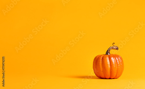 Halloween pumpkin decorations on a yellow-orange background