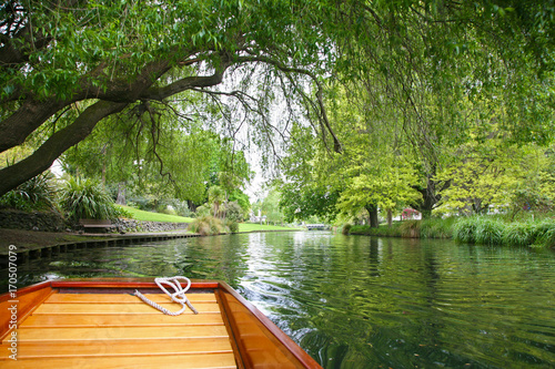 Punted along the River Avon in Christchurch New Zealand, under the green trees