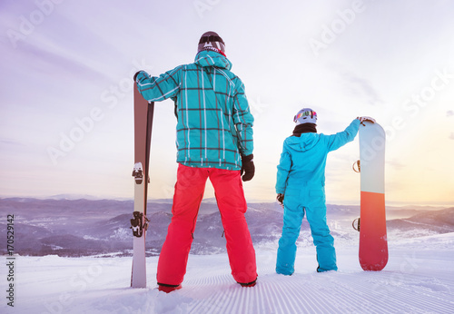 Skier snowboarder family skiing snowboarding concept