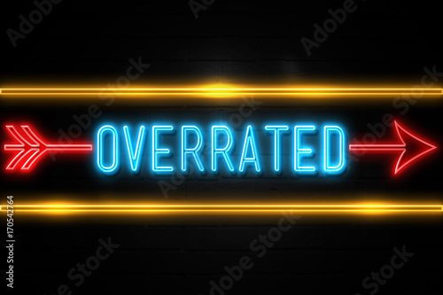 Overrated - fluorescent Neon Sign on brickwall Front view