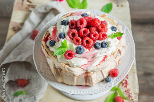 Sweet and creamy Pavlova cake with berries and meringue