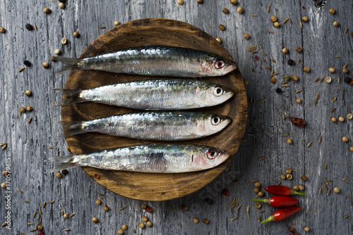 raw sardines on a rustic wooden table