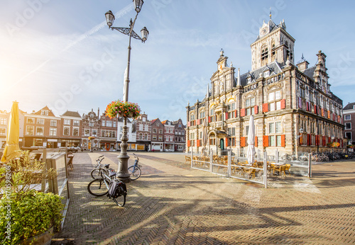 View on the Town hall and beautiful buildings on the central square during the sunny morning in Delft city, Netherland