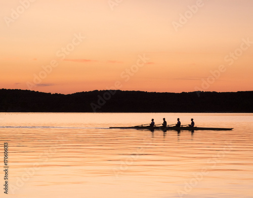 rowing on the sea at sunset