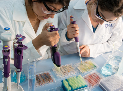 two young scientists preparing samples for further lab analysis
