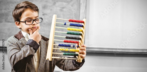 Pupil dressed up as teacher holding abacus