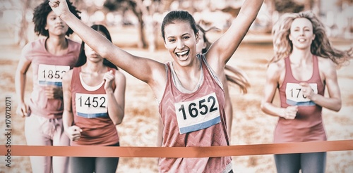 Cheering brunette winning breast cancer marathon