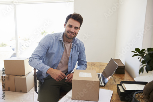 Portrait Of Man In Bedroom Running Business From Home