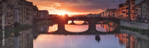 orange sunset in panorama of river and bridge in Florence in Italy