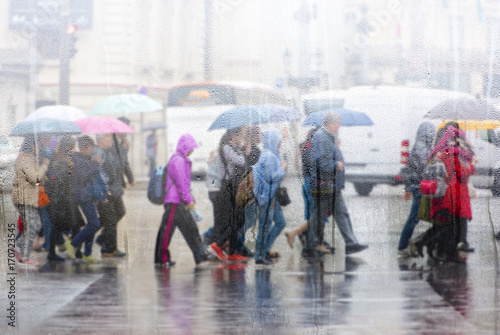 People crossing road during the rain