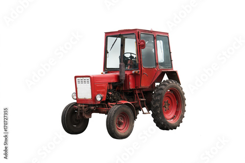 Old red farm tractor isolated