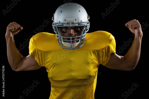 American football player flexing his muscles