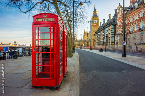 London, England - Traditional Old British red telephone box at Victoria Embankment with Big Ben at background