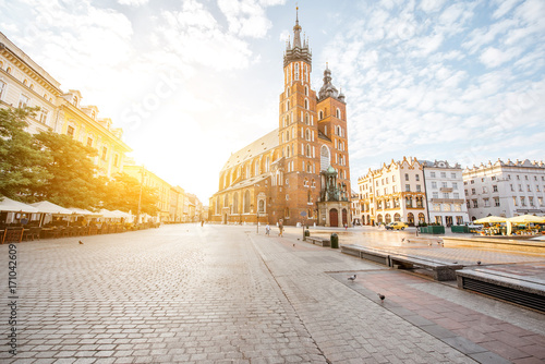 Cityscape view on the Market square with famous saint Marys Basilica during the sunrise in Krakow, Poland
