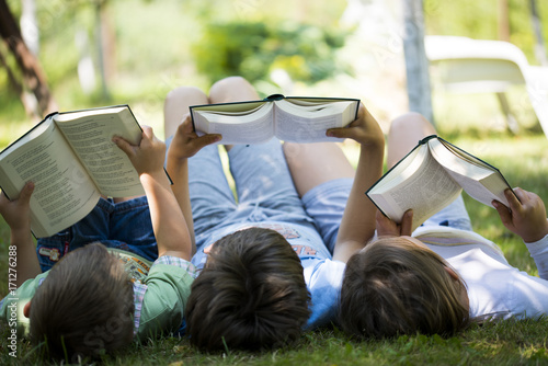 Three children reading in the garden