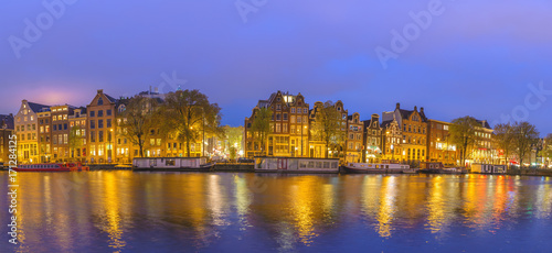 Amsterdam sunset panorama city skyline at canal waterfront, Amsterdam, Netherlands
