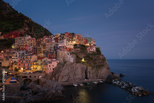Stunning view of the beautiful and cozy village of Manarola in the Cinque Terre National Park at night. Liguria, Italy.