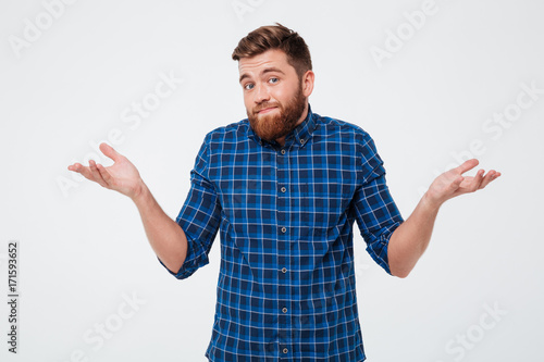 Confused young bearded man standing