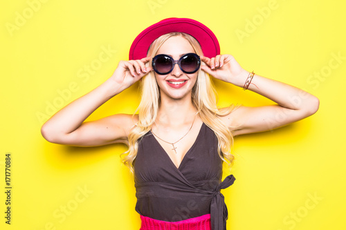 Full Length Portrait of Trendy Hipster Girl Standing at the Yellow Brick Wall Background. Urban Fashion Concept.