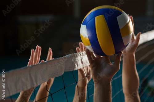 Cropped hands of players practicing volleyball