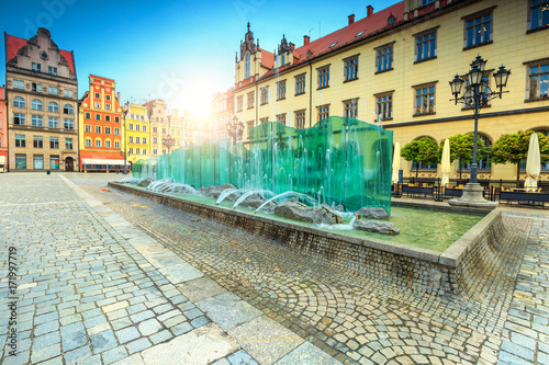 Spectacular glass fountain in square with colorful houses, Wroclaw, Poland
