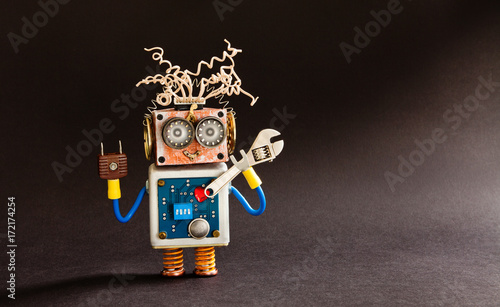Crazy serviceman robot ready with adjustable spanner. Creative design cyborg toy, electric wires hairstyle, big eyeglasses, electronic circuit body, red heart. black background copy space