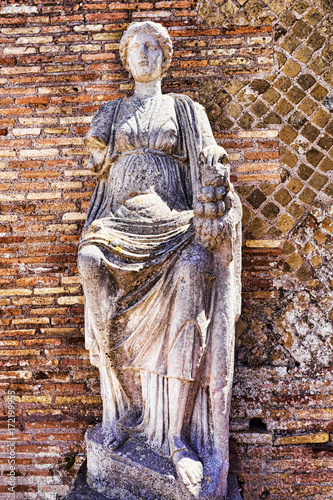 Ancient Roman Statue of Goddess Fortuna Annonaria in the courtyard of the Domus of Fortune Annonaria in Rome
