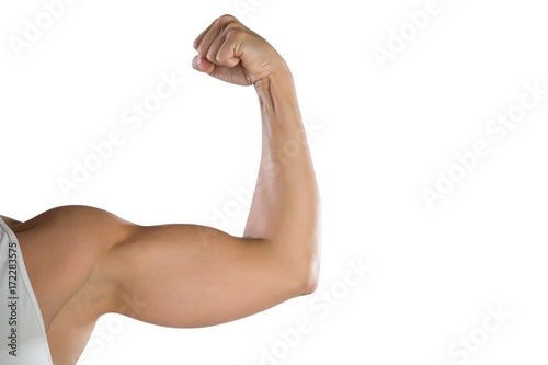 Cropped image of sportswoman flexing muscles