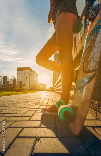 Skateboarder girl sunrise lifestyle. Longboard