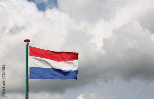 Dutch flag waving with cloudy sky background