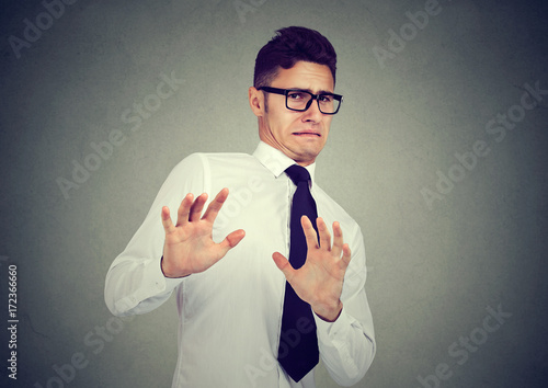 Disgusted business man isolated on gray background