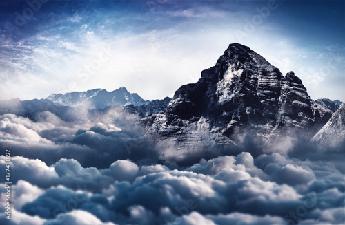 Majestic, snow capped mountain peak and cloud tops