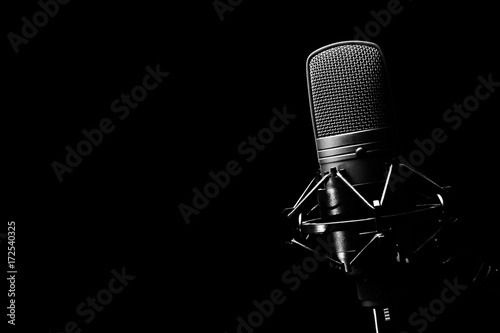 studio condenser microphone, isolated on black. copy space on left