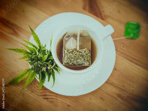 Cannabis tea from green leaf in cup, cannabis leaves tea bag,